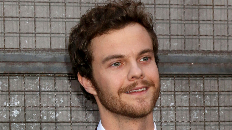 Jack Quaid smiling at event