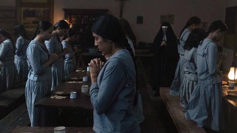 Residential school students praying