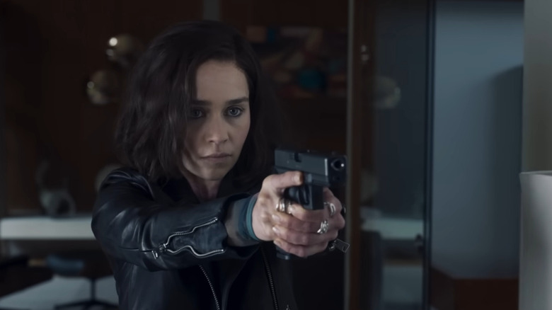 Emilia Clarke holding gun