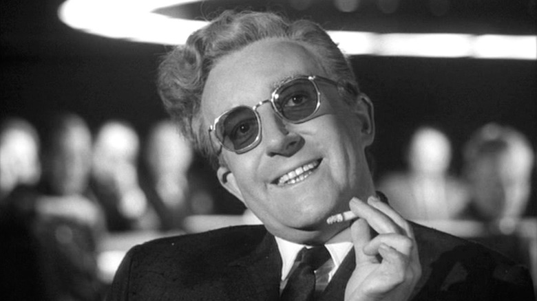 Strangelove smokes a cigarette