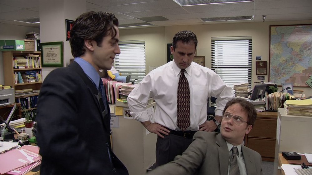 B.J. Novak as Ryan Howard, Rainn Wilson as Dwight Schrute, and Steve Carell as Michael Scott, in The Office's pilot