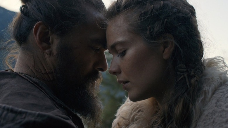 Jason Momoa and Hera Hilmar lean together