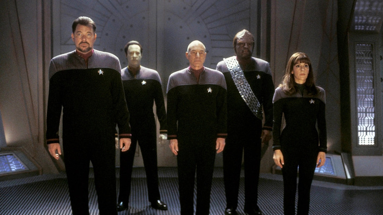 The main cast of Star Trek: Nemesis stands in a line-up