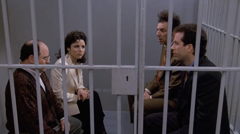 George, Elaine, Kramer, and Jerry in a jail cell