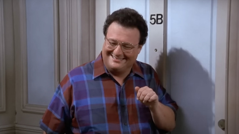 Newman standing by door