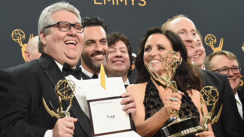 David Mandel and Julia Louis-Dreyfus holding awards