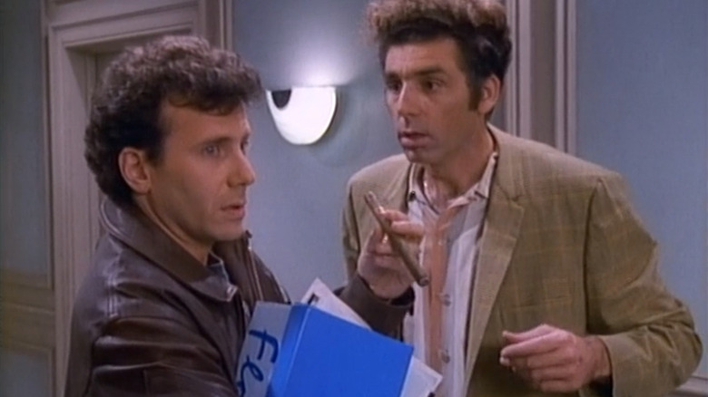 Paul Buchman and Kramer standing in hallway