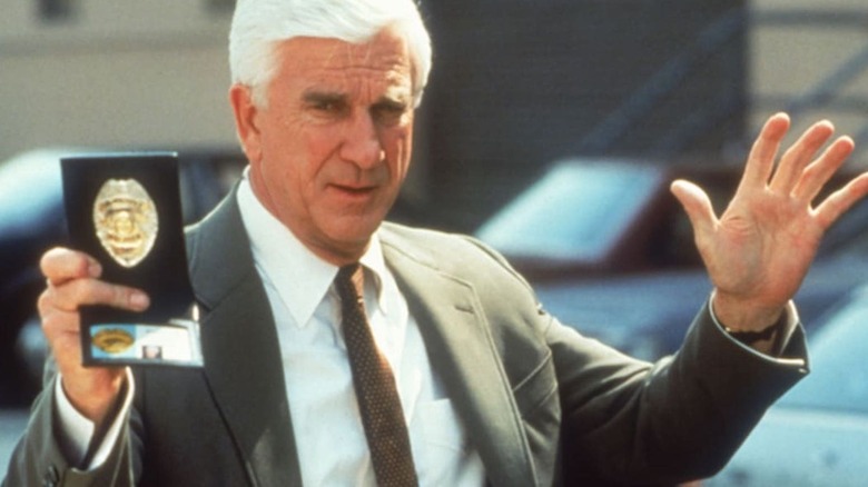 Frank Drebin showing his badge