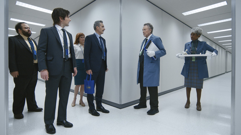 The Severance cast standing in a hallway