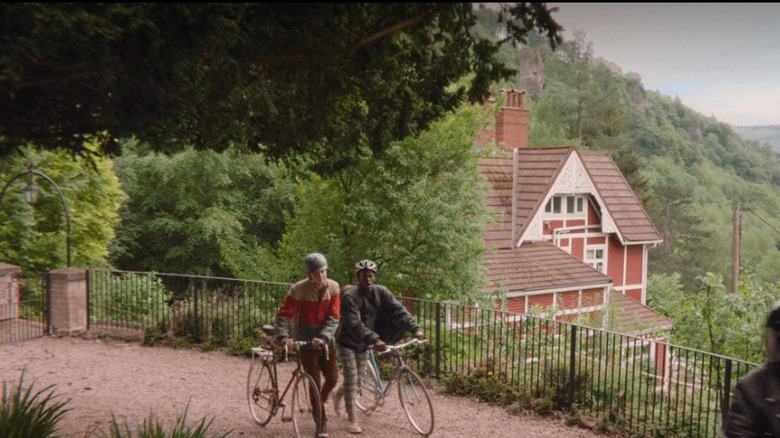 Asa Butterfield and Ncuti Gatwa walking with bikes