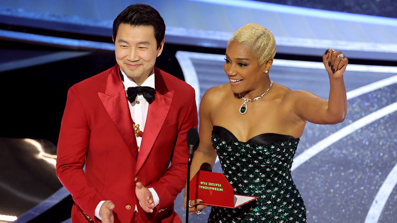 Simu Liu presenting at the Oscars with Tiffany Haddish