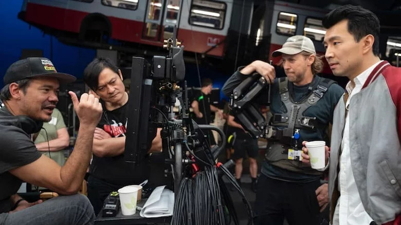 The cast and crew of Shang-Chi rehearsing the bus fight