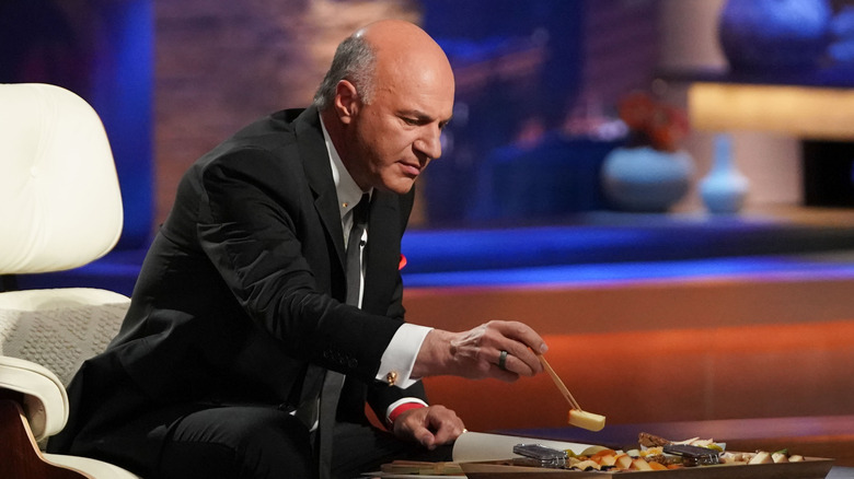 Kevin O'Leary picking up a piece of food