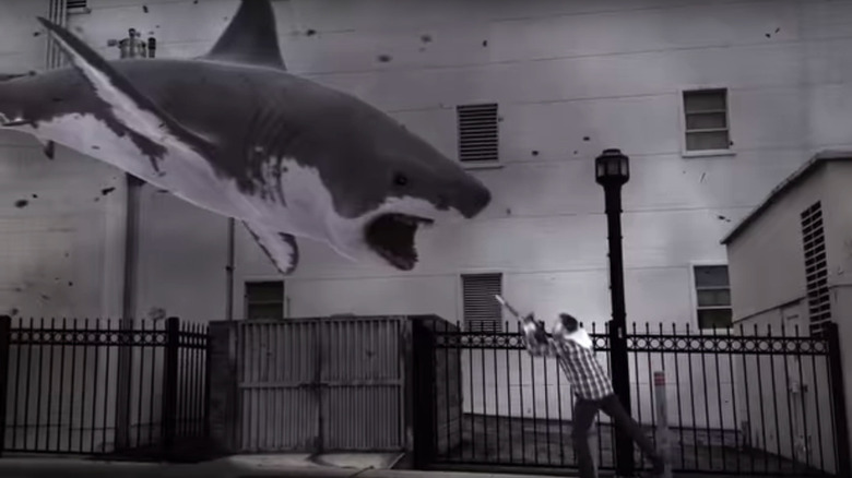 Ian Ziering confronting a flying shark with a chainsaw in Sharknado