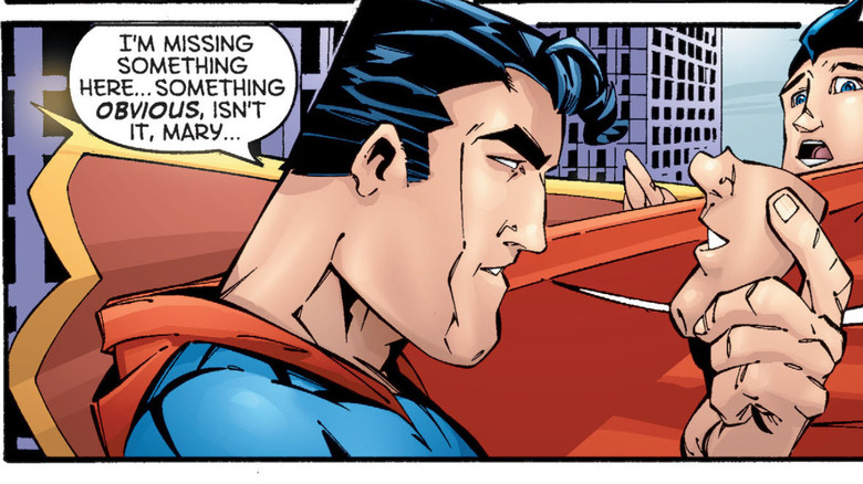 Superman holding Captain Marvel's severed chin