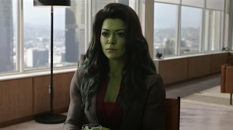 She-Hulk seated in a high-rise office building