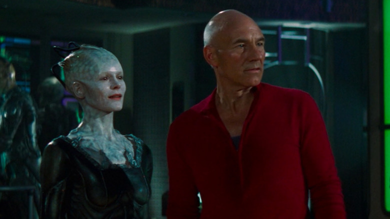 The Borg Queen stands next to Captain Picard