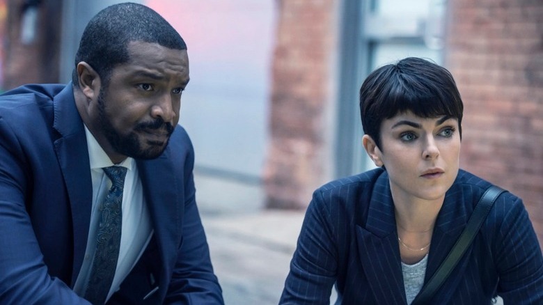 Roger Cross as Donovan McAvoy and Serinda Swan as Jenny Cooper on Coroner