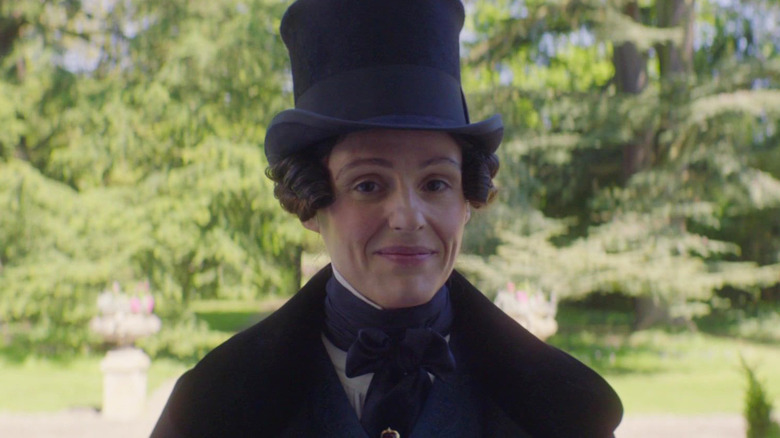 Anne Lister smiles wearing top hat