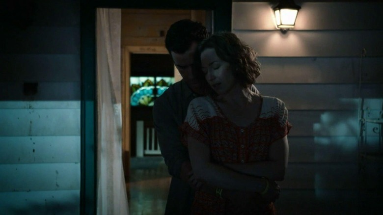 Kevin and Nora embrace on the porch