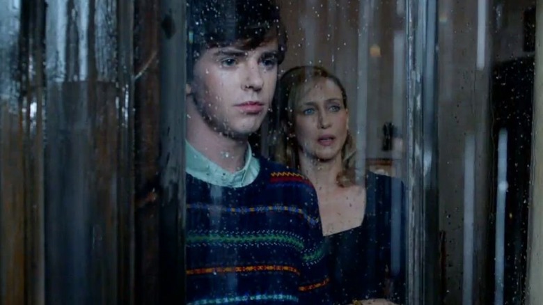 Norma and Norman Bates look out window