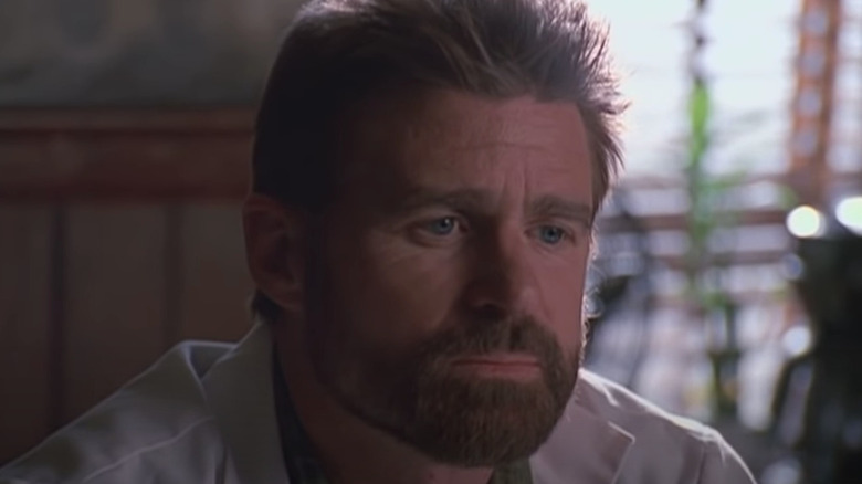 Treat Williams in lab coat stares longingly into the distance