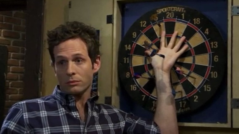 Dennis being hit with darts