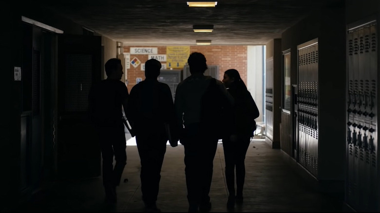 Silhouetted students in school hallway