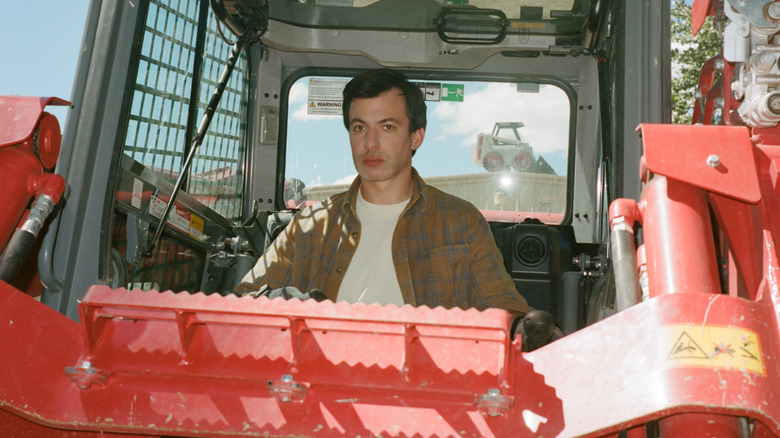 Asher in construction vehicle