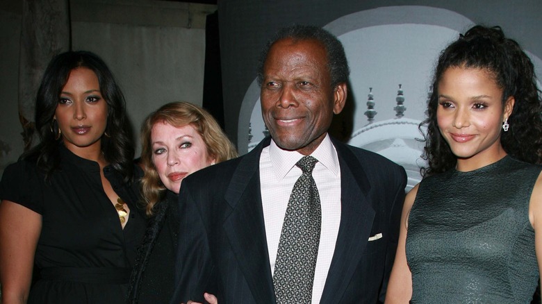 Sidney Poitier smiling with other actors