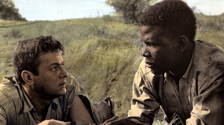 Sidney Poitier Tony Curtis lie in grass