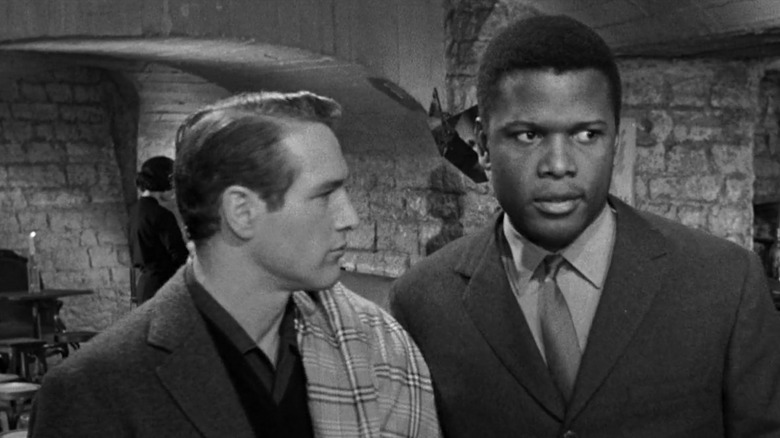 Paul Newman looks at Sidney Poitier in Paris Blues