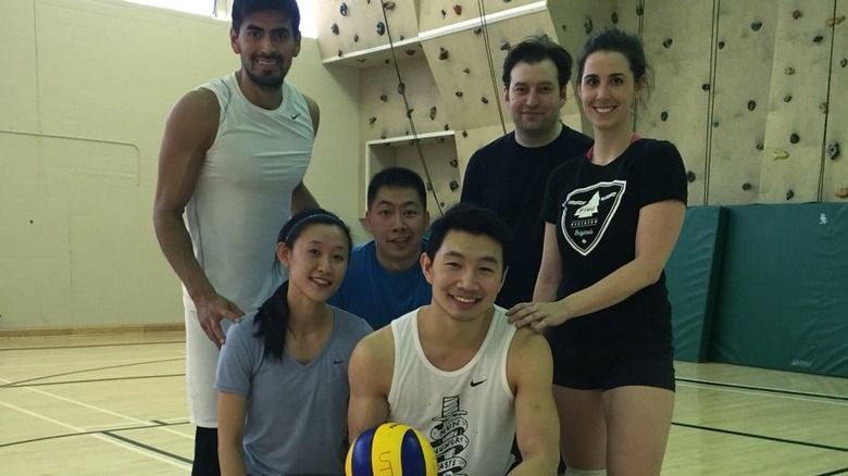 Simu Liu posing with fellow volleyball players