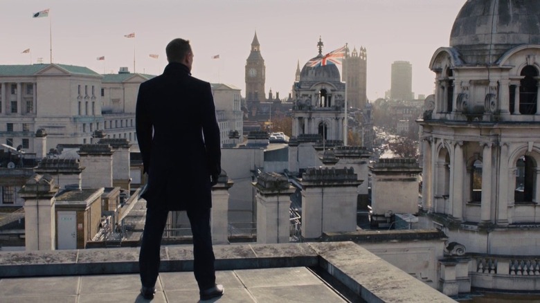 James Bond stands on a rooftop