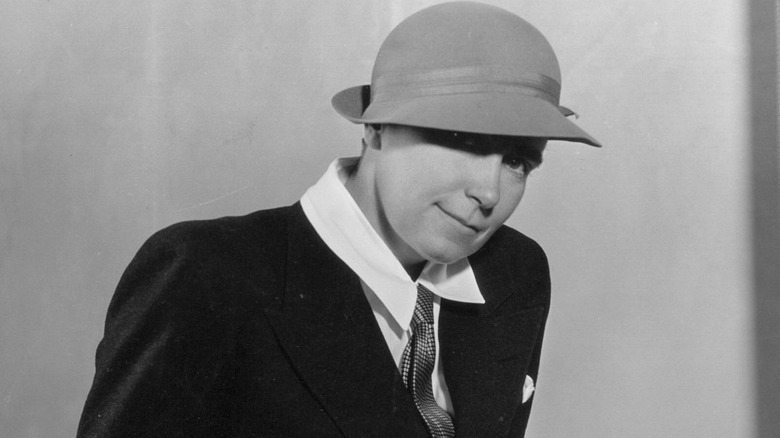 Dorothy Arzner poses in suit in office