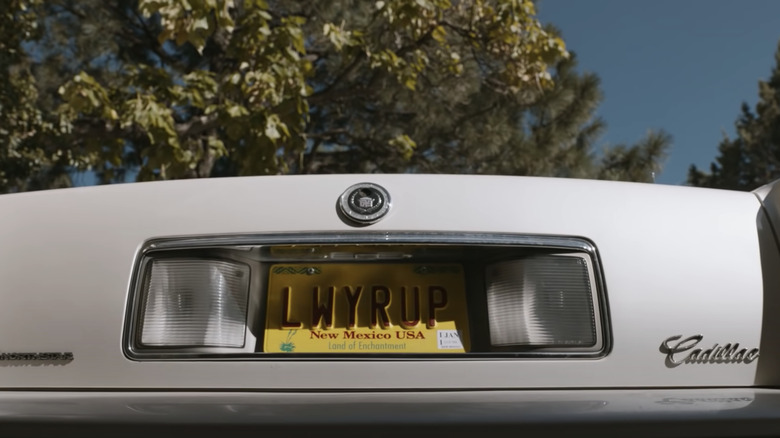 White Cadillac reads LWYRUP license plate