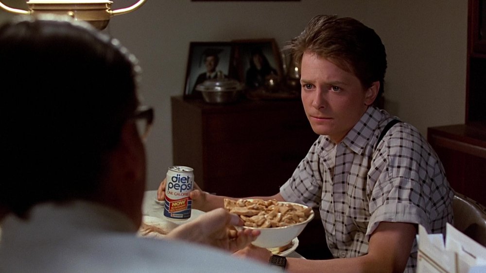 Michael J Fox as Marty McFly holds a Diet Pepsi can while talking to Crispin Glover as George McFly in 1985 version 1 in Back to the Future