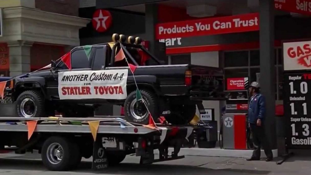 A shiny black custom Toyota 4X4 from the Statler dealership outside the Texaco in Back to the Future