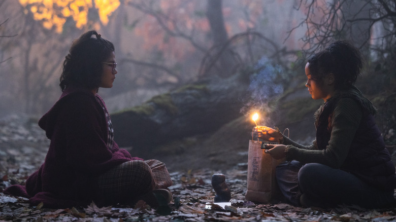 Whitney Peak and Belissa Escobedo light the black flame candle