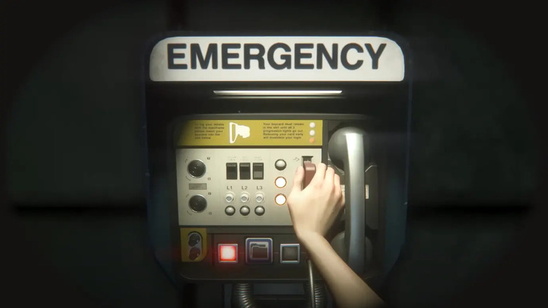 Hand reaching for emergency phone