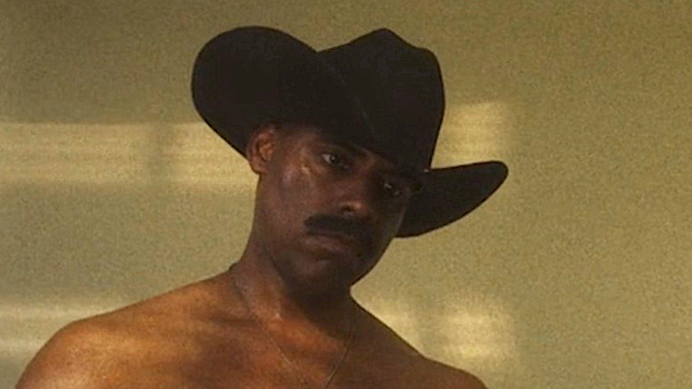 Shirtless man wearing cowboy hat