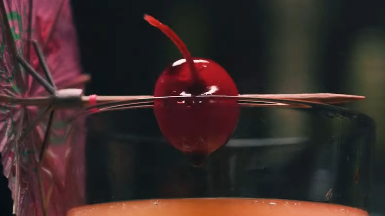 Maraschino cherry on cocktail glass