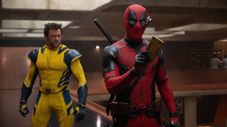 Wolverine standing behind Deadpool