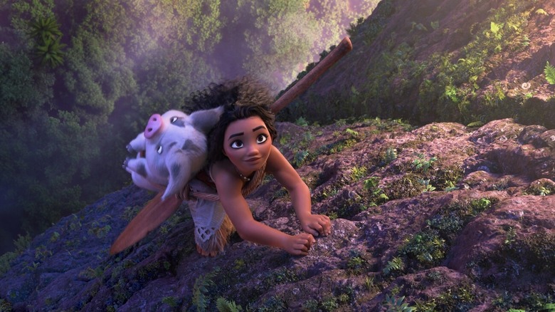 Moana climbs up a cliff with Pua on her back in "Moana 2" (2024)