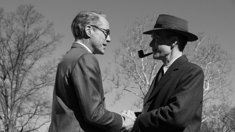 Strauss and Oppenheimer shake hands