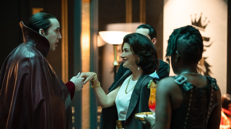 Nicolas Cage as Dracula holding Shohreh Aghdashloo's hand