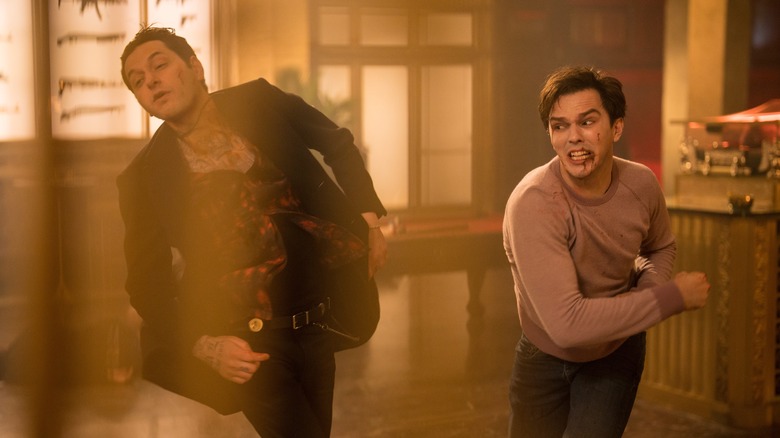 Ben Schwartz getting punched by Nicholas Hoult while running