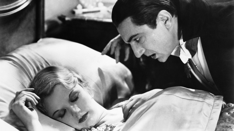 Dracula leaning over a sleeping woman