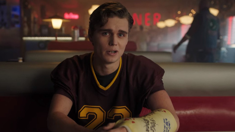 Billy sitting at a booth in the diner