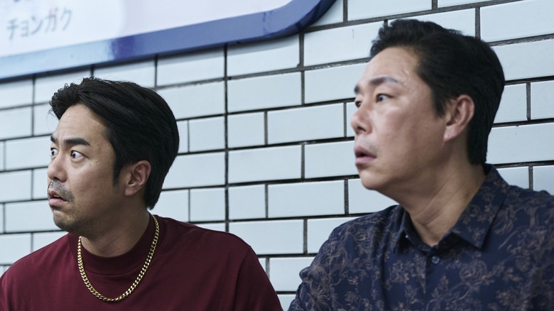 Woo-seok and Mr. Kim spotting the Salesman